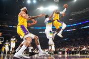 Derrick Favors of the New Orleans Pelicans doesn’t have a chance to stop LeBron James when the Laker is that high in the air on his way to the basket. Wally Skalij / Los Angeles Times