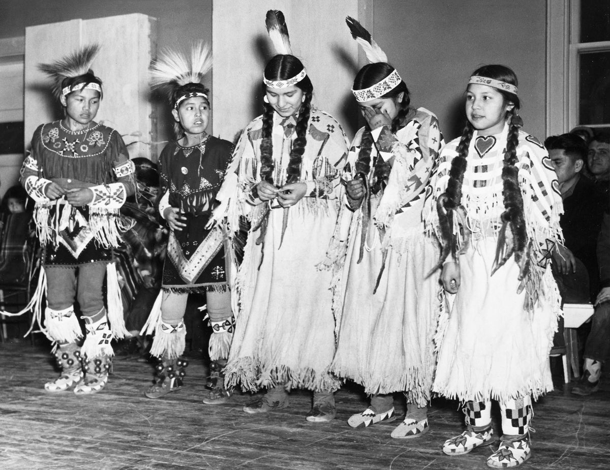Nez Perce boys and girls dancing at one of the war dances at Lapwai Indian agency, February 23, 1952. Left to right, Ronnie Tilleques, Delco White, Barbara Johnson, Patsy Higheagle and Regina Tilleques. Courtesy Lewiston Morning Tribune