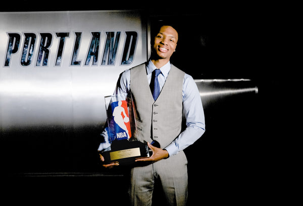 Damian Lillard is awarded the trophy for 2013 Rookie Of The Year. Bruce Ely / The Oregonian
