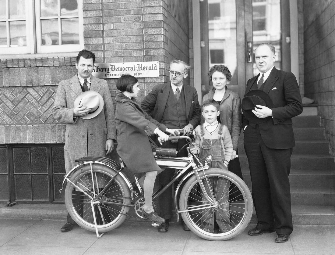 Beverly (Berks) Spencer riding the bike she just won in a Democrat-Herald contest, circa 1930. W. L. Jackson is at center, and Bud Spencer is behind the front wheel. Courtesy Albany Regional Museum
