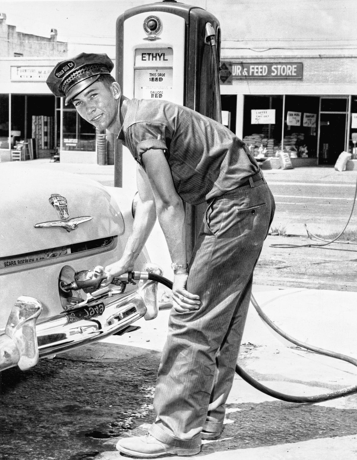 Jerry Dykes, son of Frances Ulmer and Jake Dykes, pumping gas at Sing Station in Valdosta, circa 1955. Georgia Ann Dykes