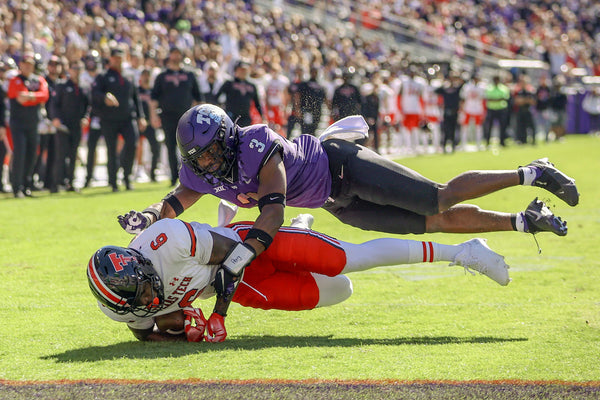 TCU safety Mark Perry tackles OSU wide receiver J.J. Sparkman during their game against Texas Tech at the Amon G. Carter Stadium in Fort Worth on Oct. 15, 2022. (Madeleine Cook / Fort Worth Star-Telegram)