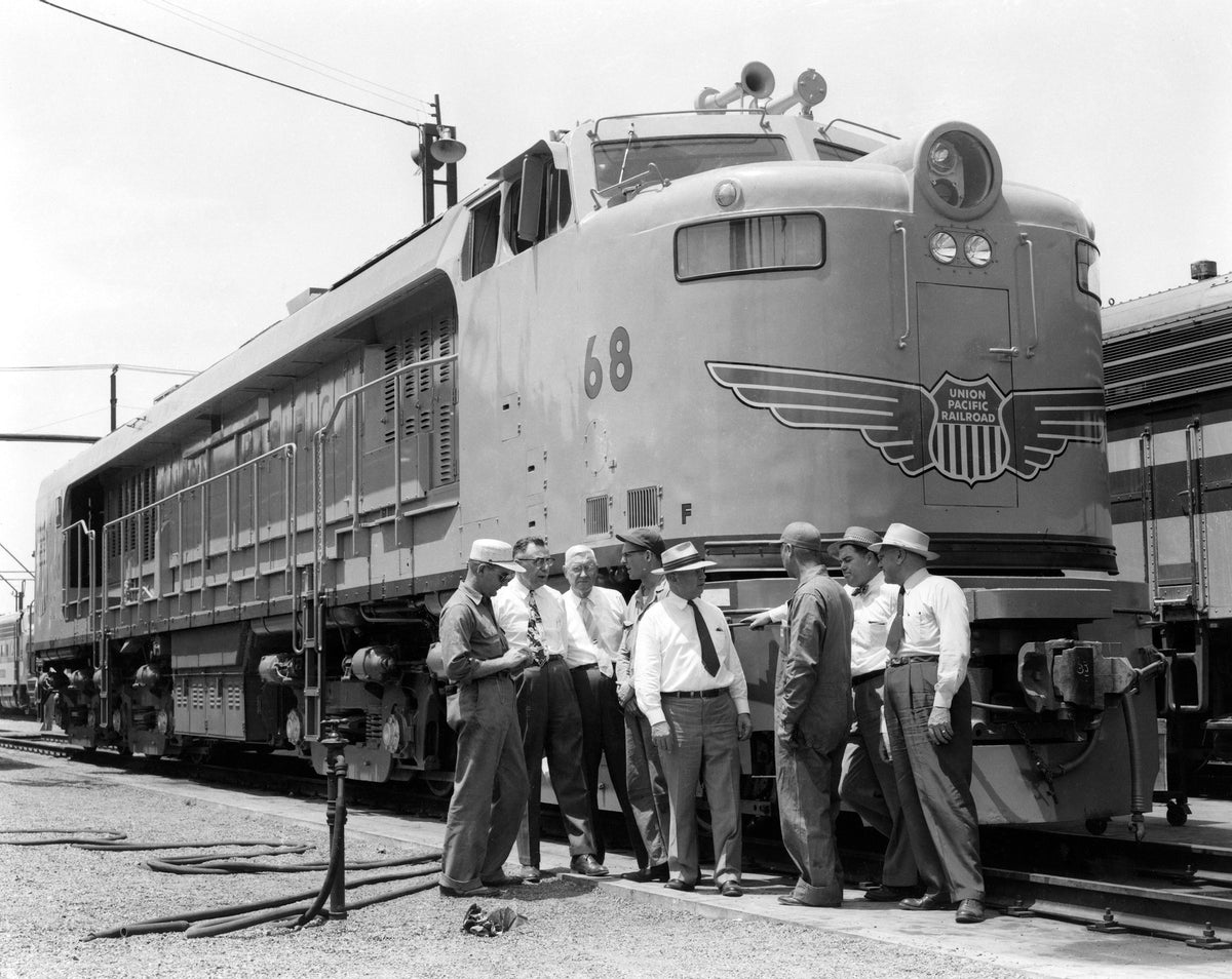 Men standing outside of the Union Pacific Railroad gas turbine engine in 1954. Courtesy Decatur Public Library