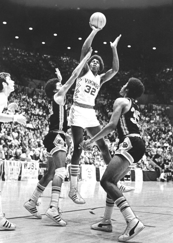 A little love tap on the arm couldn’t stop Magic Johnson from getting off his shot against Birmingham Brother Rice in the 1977 Class A championship game on March 26. JOHN COLLIER/DETROIT FREE PRESS