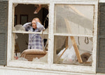Carol Pritchard pausing for a moment while searching for belongings in her brother’s Mapleton house on April 10, 2011, after a tornado devastated part of the town. Sioux City Journal