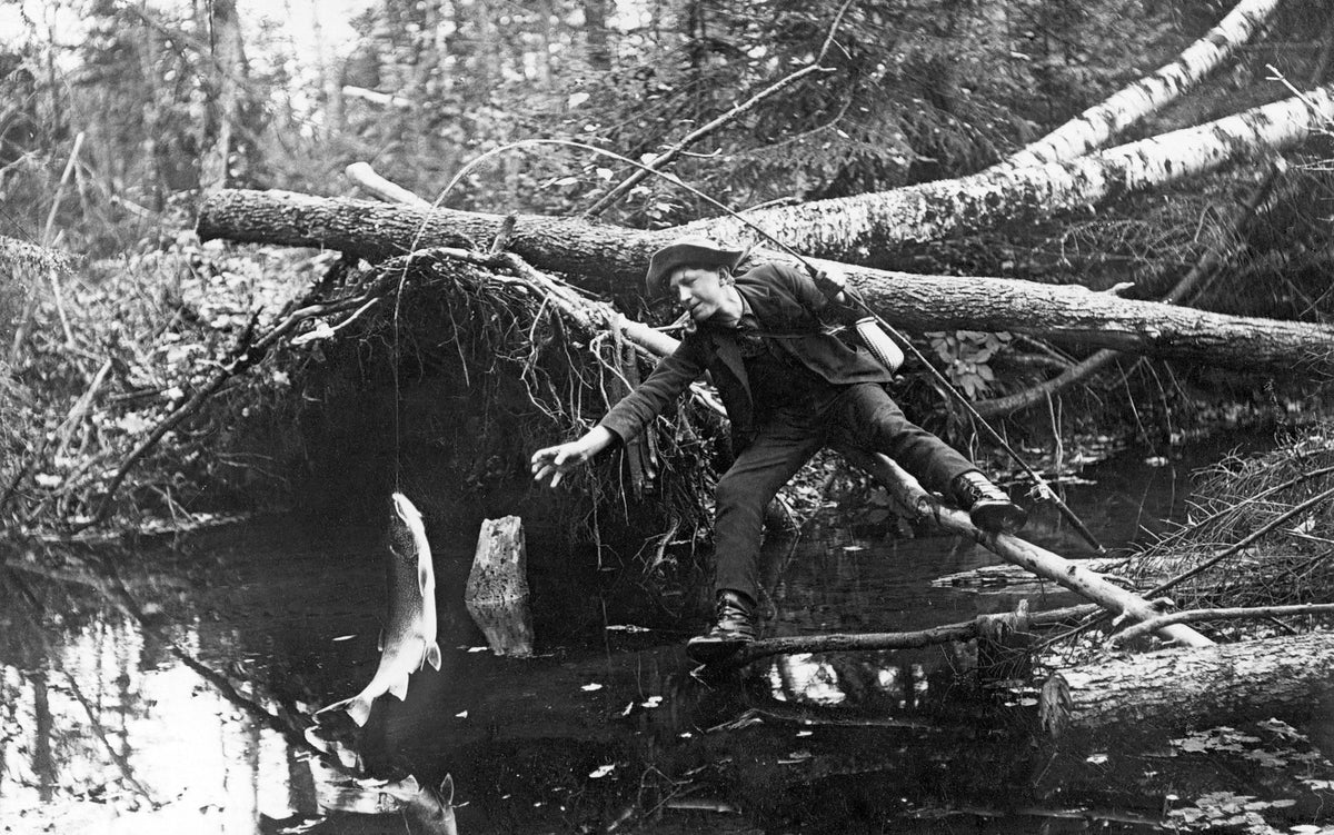 A man catching a fish near Marshfield, 1911. Courtesy Marshfield Public Library