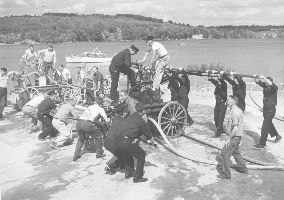 Meredith Fire Department participating in a pump contest with the department’s early pieces of firefighting equipment, circa 1958. Jim Kitching and Bud Cotton are on top of the pump at center. The pumps date back to the 1800s. Don Smith, Meredith Fire Dept.