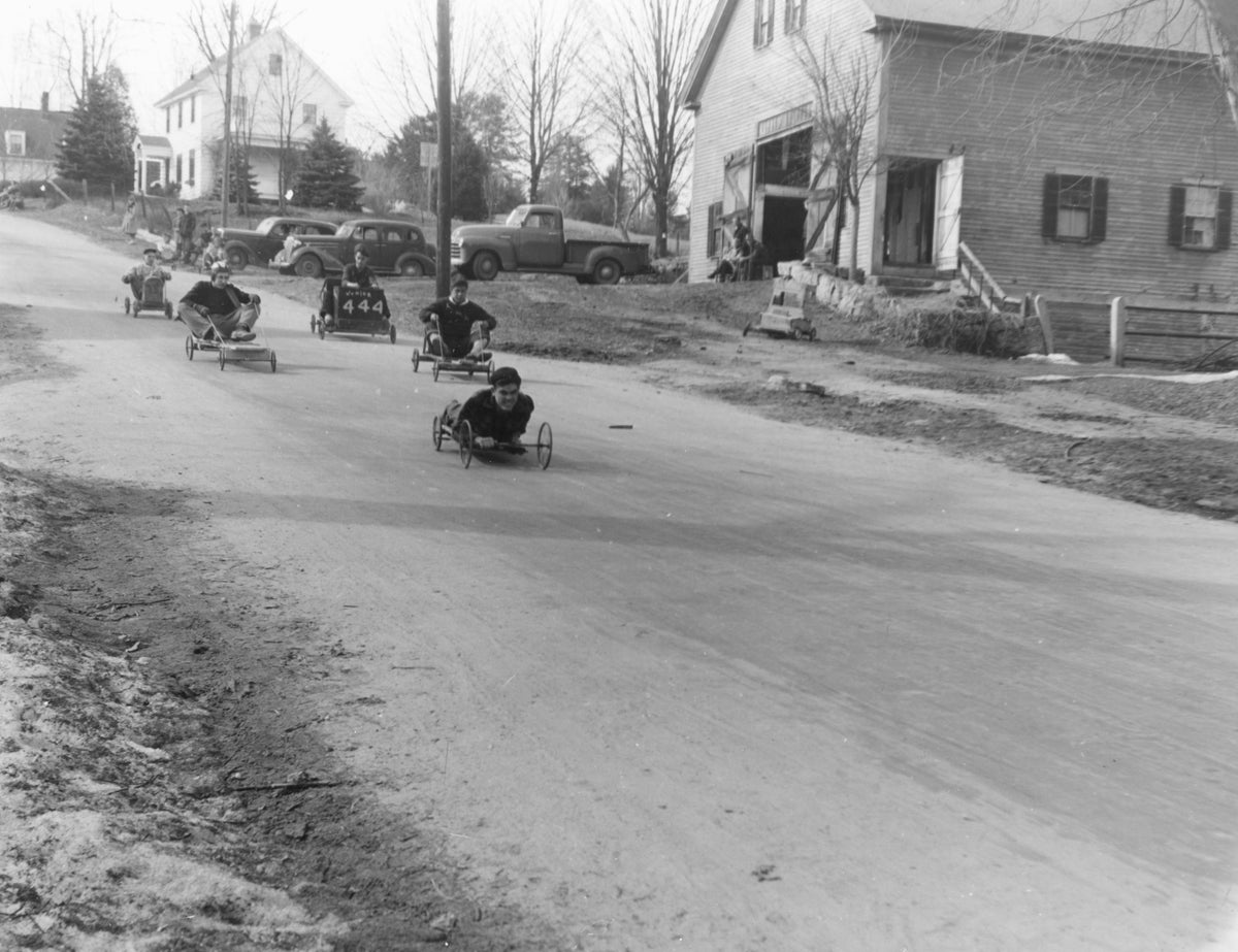 The “Triple 4” club racing down Red Gate Lane, circa 1950. Among those pictured are Jim Jackson (front), Larry Gagne, Junior Weeks and John Nelson. Meredith Historical Society