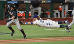 Dodgers third baseman Justin Turner was fully extended to tag Dansby Swanson in the fourth inning. It was part of a multi-player sequence that resulted in a double play. Robert Gauthier / Los Angeles Times