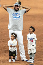 Kenley Jansen celebrates with his children Kyrian, left, and Kayden after the Dodgers 4-3 win over the Atlanta Braves in the clinching game of the NLCS. Robert Gauthier / Los Angeles Times