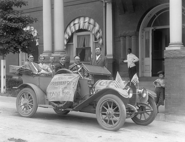 Central Highway scout car in front of Hotel Raleigh, circa 1911. Fred A. Olds and Joseph Hyde Pratt are in the back seat. Courtesy State Archives of North Carolina / #N.53.17.515