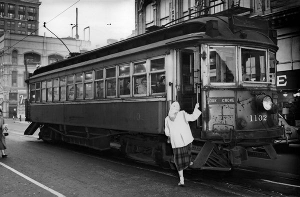 Woman boarding a trolley, circa 1952. The Oak Grove designation on the trolley indicates that it ran on the electric interurban line that once connected Oregon City and Milwaukie with Portland. In 1958, the Portland Transit Company shut down all interurban lines, ending 65 years of service. Courtesy Oregonian Archives