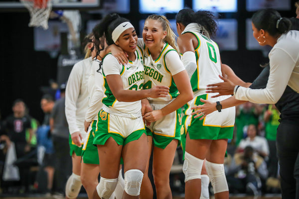 Minyon Moore (left) and Jaz Shelley celebrate during the second half as the No. 1 seed Oregon Ducks beat the No. 3 seed Stanford Cardinal 89-56 in the championship game of the Pac-12 women's basketball tournament on March 8, 2020, at Mandalay Bay Events Center in Las Vegas. Courtesy Serena Morones, The Oregonian/OregonLive