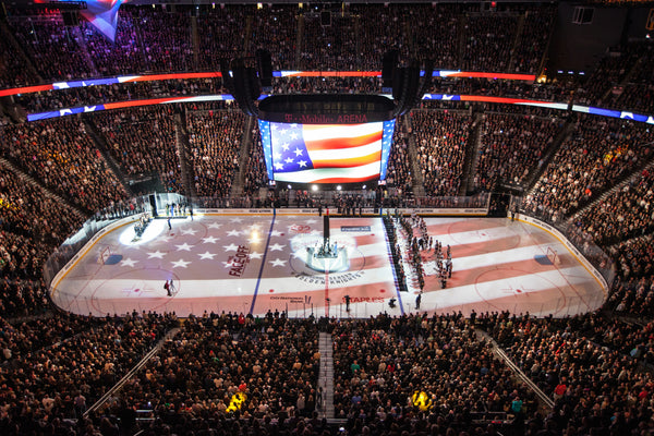 The American flag is displayed on the hockey ring during a ceremony honoring victims and first responders of the Route 91 Harvest Festival shooting before the start of an NHL hockey game between the Vegas Golden Knights and the Arizona Coyotes at T-Mobile Arena in Las Vegas, Tuesday, Oct. 10, 2017. Courtesy Joel Angel Juarez/Las Vegas Review-Journal