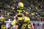 Oregon offensive lineman Shane Lemieux lifts running back Cyrus Habibi-Likio (33) in celebration after Habibi-Likio’s one-yard touchdown run against the Golden Bears. Courtesy The Oregonian / Sean Meagher