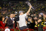 Oregon coach Mario Cristobal lifts the Rose Bowl trophy after the Ducks beat the Wisconsin Badgers 28-27 in the 106th Rose Bowl in Pasadena, California. Courtesy The Oregonian / Sean Meagher