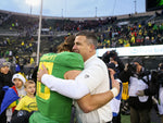 Oregon coach Mario Cristobal embraces quarterback Justin Herbert after the Ducks’ 24-10 Civil War win. In his final game at Autzen Stadium, Herbert was 18 of 30 for 174 yards and a touchdown. Courtesy The Oregonian / Sean Meagher