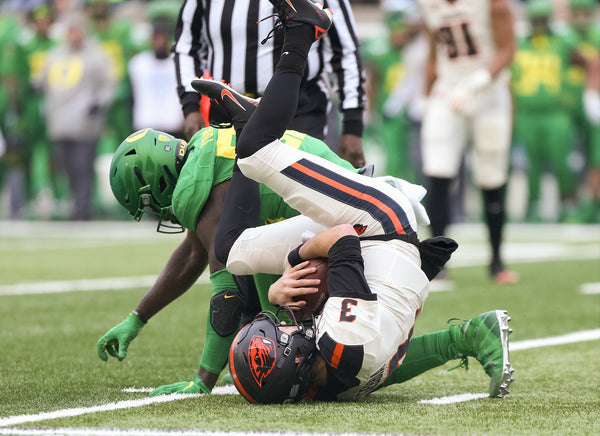 Oregon State quarterback Tristan Gebbia (3) is dropped by Oregon linebacker Bryson Young during the Ducks’ 24-10 Civil War victory in Eugene. Courtesy The Oregonian / Sean Meagher