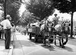 Alumni parade during class reunion weekend, June 1955. Milton Eisenhower is riding in the wagon with the oldest alumnus (who is not visible). Behind the president in the wagon sits the Reunion Ragtimers, a band made up of alumni. Marching behind the wagon are the reunion classes, beginning with the oldest. Photo was taken on Pollock Road in front of Willard Hall. The destination was Schwab Auditorium. Penn State University Archives, Paterno Library