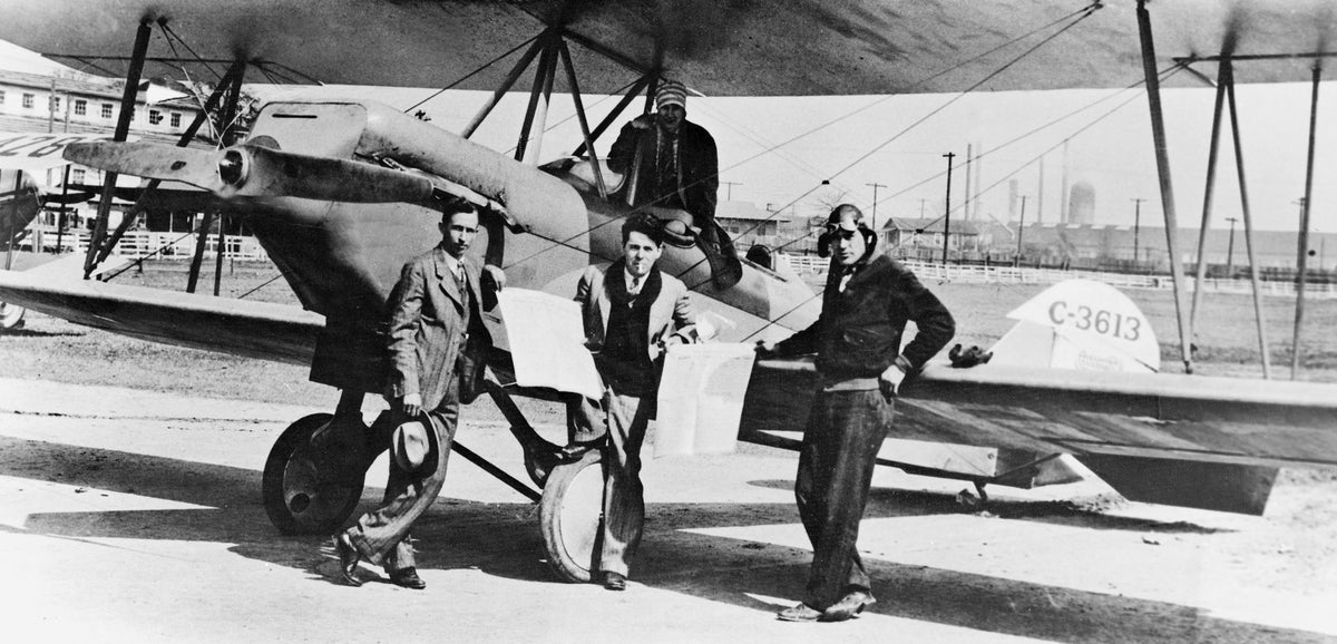 Mr. and Mrs. Fred Price, editors of the Morning Call, had the paper delivered by plane to surrounding towns in the trade area, circa 1927. Lt. Rainey, retired military pilot delivered the newspaper in the morning. Another plane (No. 4287) to the far left of the photo, flew the Laurel Daily Leader in the afternoon until it was wrecked the same year this photo was taken. The photo was taken at the old Fairgrounds at the soutwest corner of Jefferson and Magnolia streets.