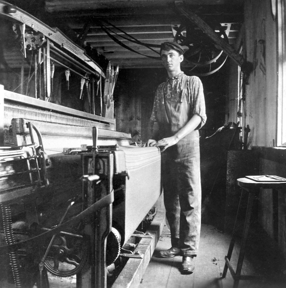 Aug. Burkhardt standing next to a blanket on a loom at a wool mill in Zoar, 1898. Courtesy Ohio History Connection / #P223_B04_Series2Album2_088