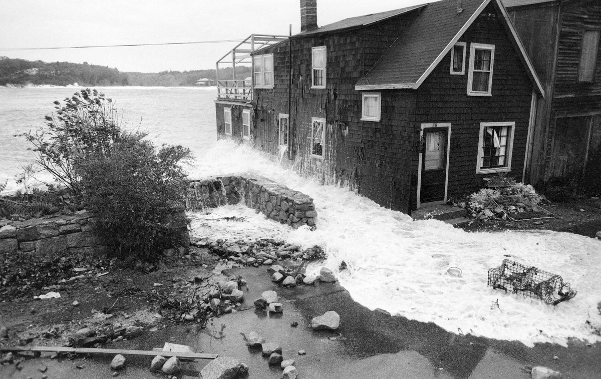 The tide surge from Magnolia Harbor surrounds Edna Smith’s Shore Road home. Cristin Bradley/Gloucester Daily Times