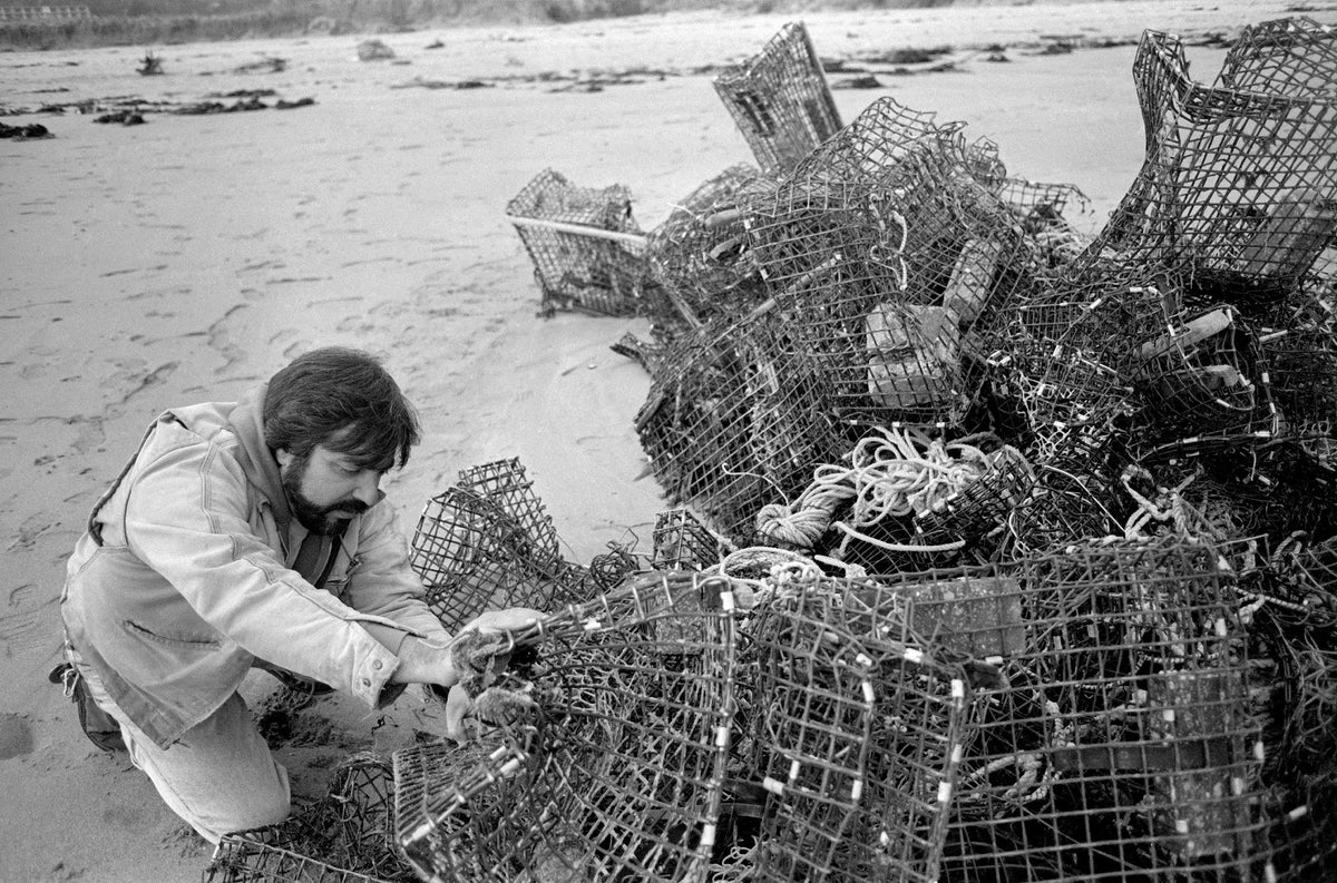 Public Works employee Charlie Nicastro attempts to untangle a pile of lobster traps knotted together by the force of the storm. Lobstermen reported losing up to 90 percent of their gear, and many went out of business for good. Cristin Bradley/Gloucester Daily Times