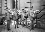 Four Portland letter carriers with heavy bundles of mail, circa 1930. Courtesy Oregon Historical Society / Neg# bb012982
