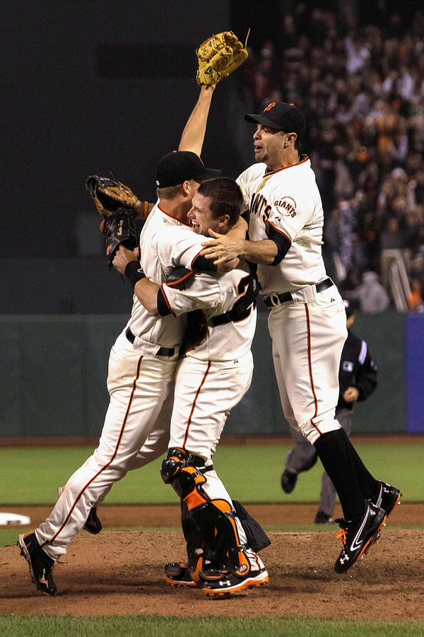 San Francisco Giants pitcher Matt Cain, left, celebrates with catcher Buster Posey, center, and first baseman Brandon Belt after the final out of the ninth inning of a baseball game against the Houston Astros in San Francisco, June 13, 2012. Cain pitched the 22nd perfect game in major league history and first for the Giants, striking out a career-high 14 and getting help from two spectacular catches to beat the Houston Astros 10-0. Jeff Chiu / AP Photo