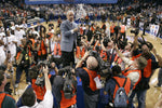 UNC coach Roy Williams acknowledges his team members and fans after cutting down the net following their ACC Tournament victory over N.C. State on March 11, 2007, in the St. Pete Times Forum. Courtesy Robert Willett / The News & Observer