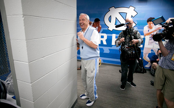 North Carolina coach Roy Williams slips into the Tar Heels locker room past media members for a beverage before heading to a press conference on March 31, 2017, at the University of Phoenix Stadium in Glendale, Ariz. Courtesy Robert Willett / The News & Observer