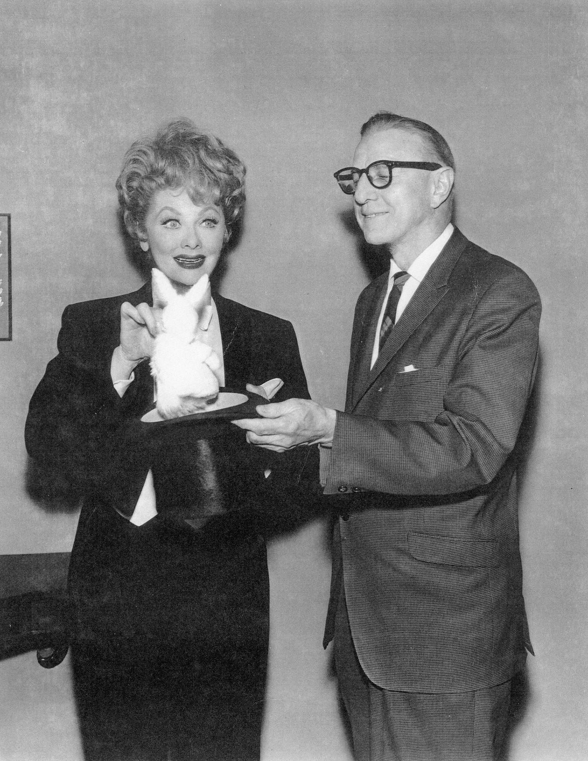 Louise St. Pierre, former manager of the Coronado Theater, went on to Hollywood to run a famous magic shop and to exercise his talents as a magician by coaching Lucille Ball and other stars of film and television in magic acts. He is seen here with Lucille Ball doing the rabbit and hat trick, circa 1960.