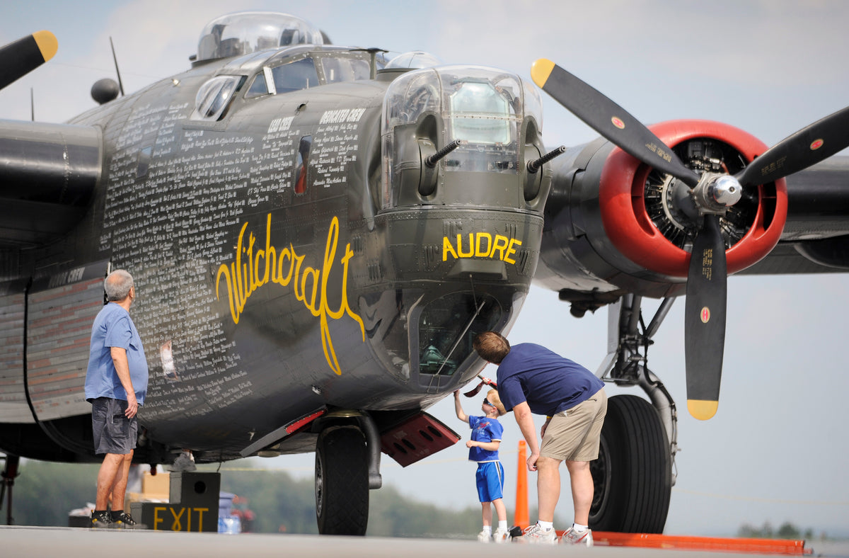 Aircraft enthusiasts of all ages viewing a World War II B-24J Liberator bomber at the airport, August 10, 2009. John Rucosky, Ken Fochtman, and his three-year-old son Jonathan are included. Courtesy The Tribune-Democrat