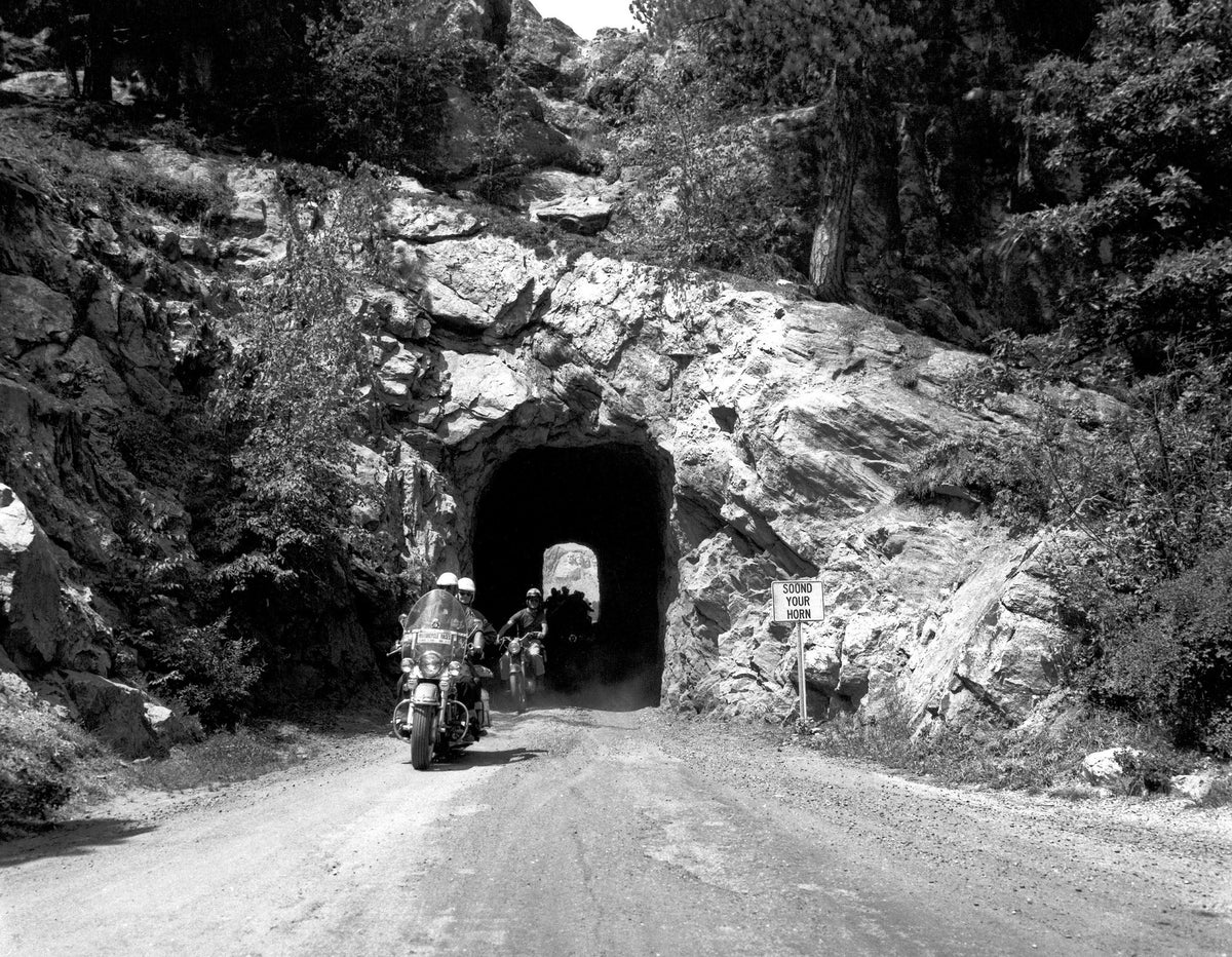 Riders make their way through one of the tunnels on Iron Mountain Road during a Jackpine Gypsy Tour.