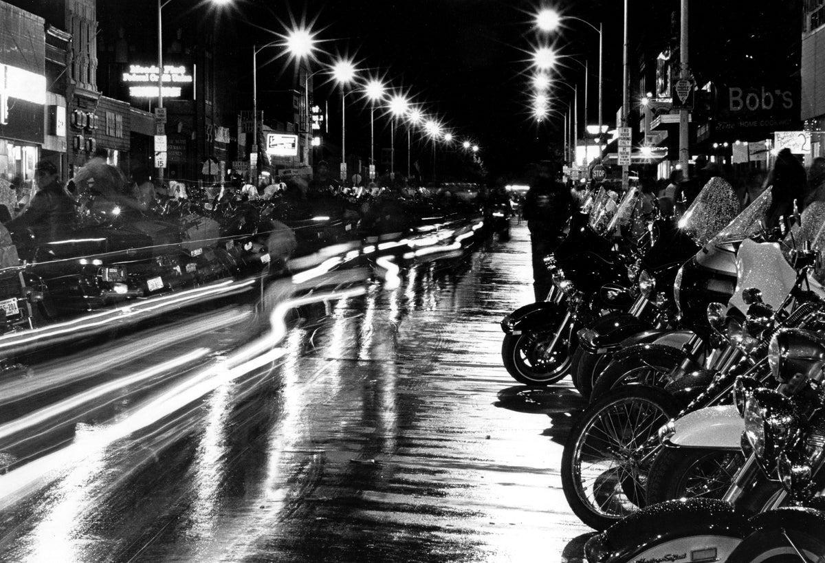 Bikers ride down Sturgis Main Street in this long exposure photograph at night during the 1967 rally.