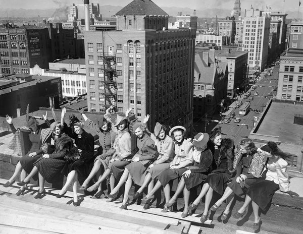 Women on the roof of the Brown Palace Hotel, in Denver wearing outfits that include leopard skin, fur, feathers, fancy hats, a plaid cape, gloves, taffeta, and high heels. Seventeenth Street and downtown commercial buildings are in the background. Courtesy Denver Public Library, Western History Collection, #Rh-1328