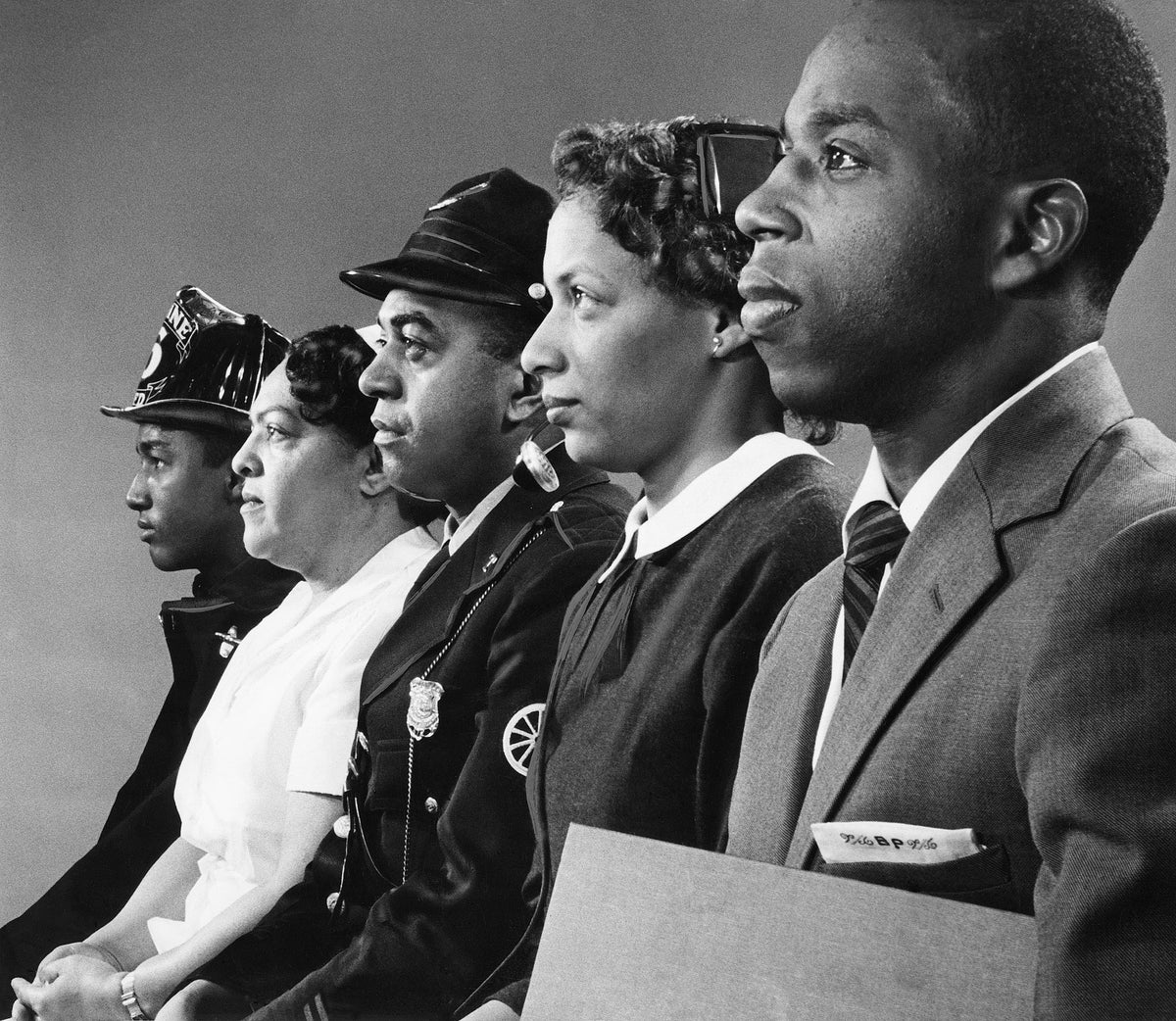 Fireman Kenneth Williams, nurse Mrs. Margery Cannal, policeman Alfred Lima, telephone operator Miss Audrey Hopkins, and teacher Bernard Pina, February 1959. Courtesy The Providence Journal