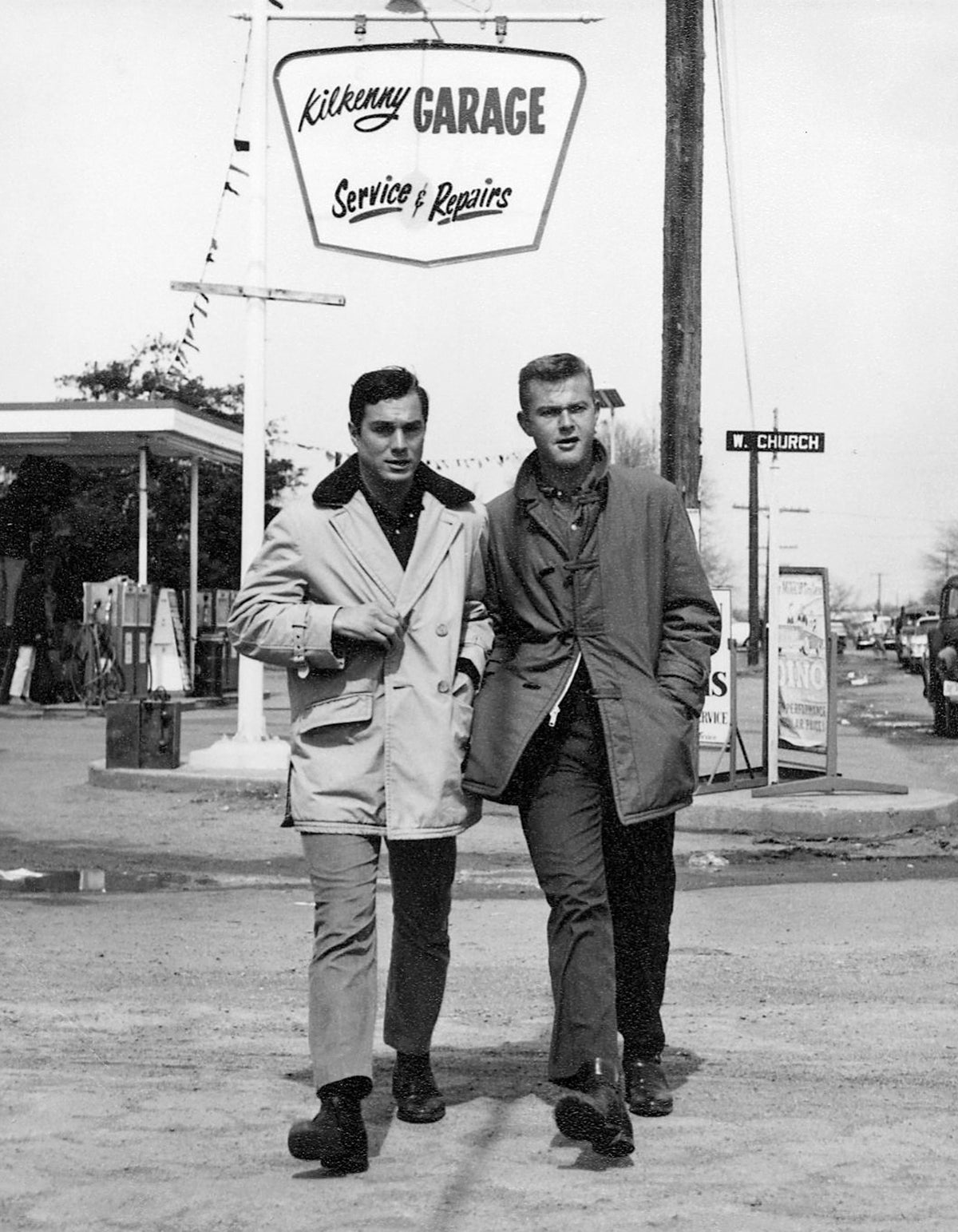 Co-stars George Maharis and Martin Milner walking away from Moseley Service Station in Lewisville, changed into the fictional Kilkenny Garage for the filming of an episode of the television series Route 66. The station was located on the northwest corner of Mill and Church Streets. This episode of Route 66, called "Love is a Skinny Kid," was filmed in Lewisville during March 1962 and aired in April 1962. Courtesy City of Lewisville - The Lewisville Collection