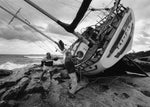 Stu Leech, left, and Rudi Schaefer inspect the 40-foot ketch Tai-Pan, which washed ashore on Schaefer’s Wamphassuc Point property in Stonington during Hurricane Bob in 1991. Skip Weisenburger, The Day