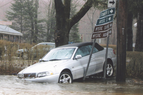 A car sits marooned on Route 27 in Old Mystic near the post office and general store during the flood of March 2010. The Indian & Colonial Research Center