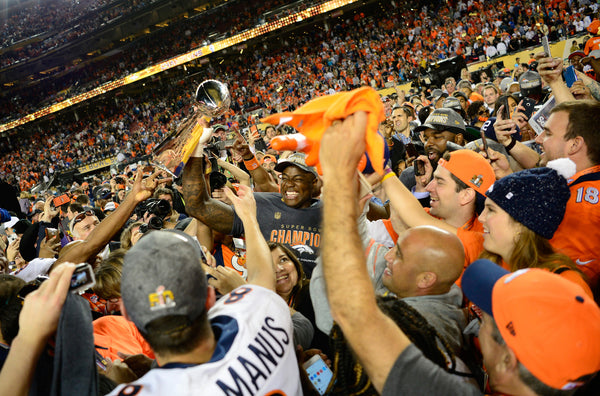 SANTA CLARA, CA - FEBRUARY 07: DeMarcus Ware (94) of the Denver Broncos hoists the trophy in a crowd of teammates and family after the game. The Denver Broncos played the Carolina Panthers in Super Bowl 50 at Levi's Stadium in Santa Clara, Calif. on February 7, 2016. (Photo by Joe Amon/The Denver Post)