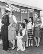 Homecoming for a sailor who is greeted by his wife, five children, and dog, circa 1955. CourtesySan Diego History Center (#OP15746-1836), Photo by Harry Bishop