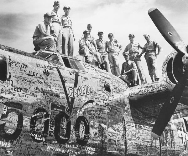 A ten-man Army Air Corps combat crew with the 7,000th Liberator produced by Consolidated Vultee Aircraft Corporation, and 5,000th to roll off the assembly lines of its San Diego division, August 18, 1944. The plane was decorated with signatures of 7,000 Convair employees. CourtesyUnion-Tribune