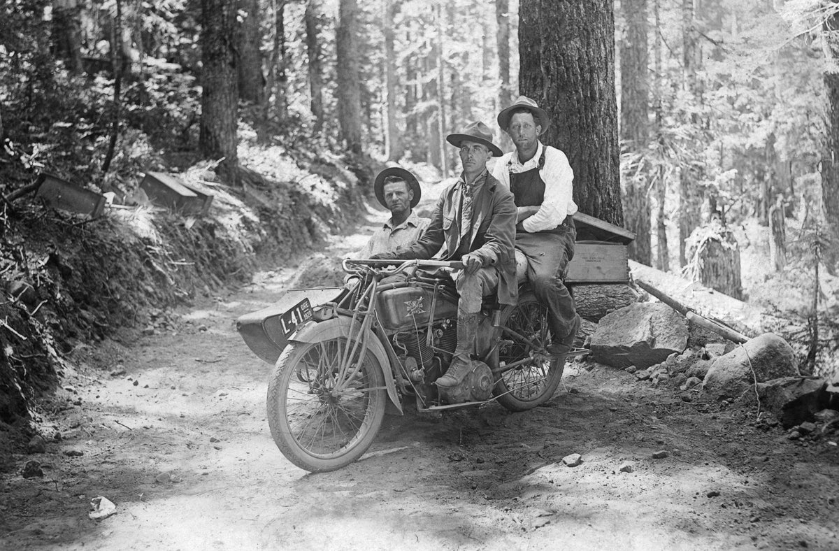 Workers during the construction of the road to Lost Lake, 1920. The men are on an Excelsior motorcycle with boxes of dynamite. Photographed by Fred Donnerberg. Courtesy History Museum of Hood River County