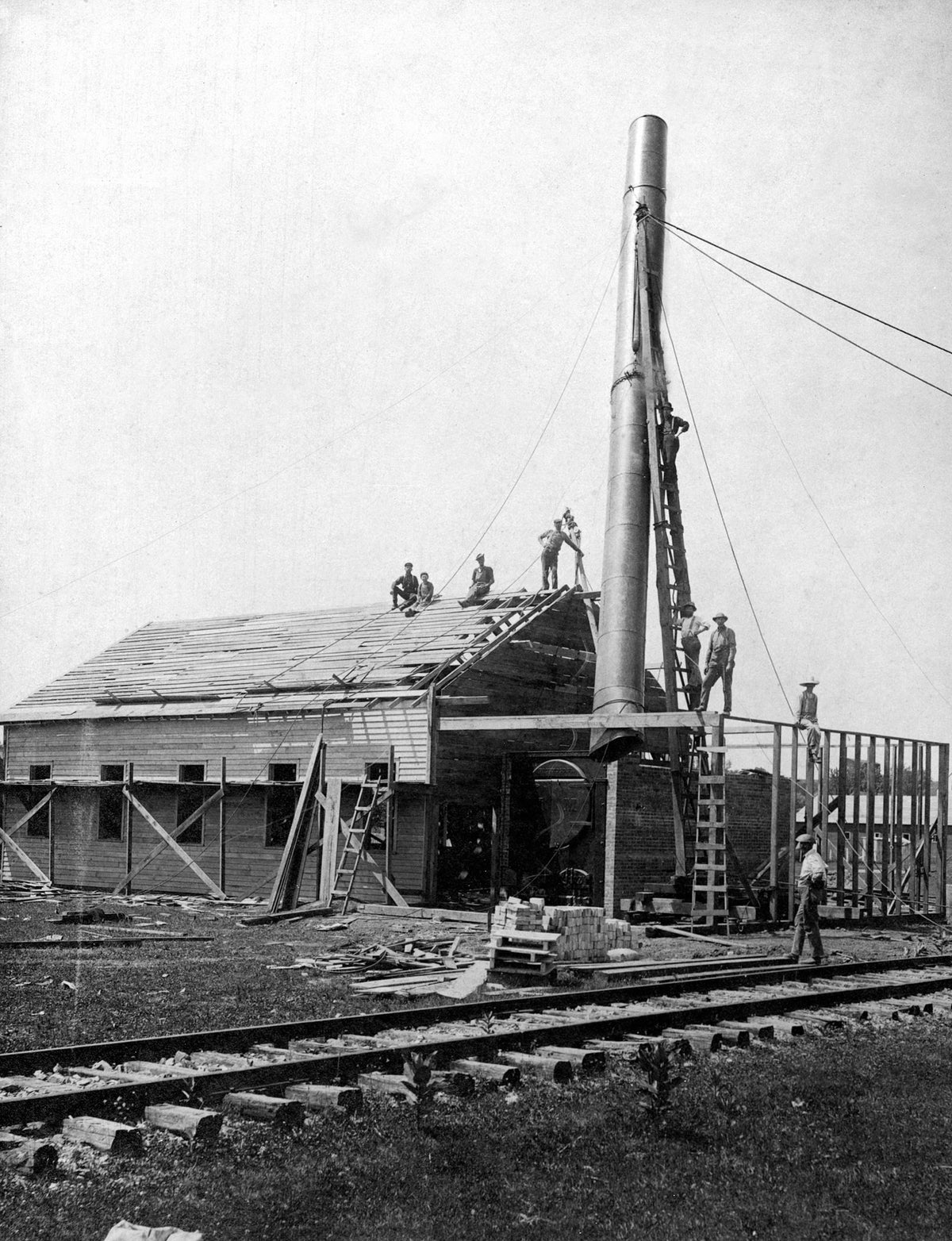 Workers raising a smokestack at a mill adjacent to a railroad, Waynesboro, circa 1901. Courtesy Waynesboro Public Library Collection