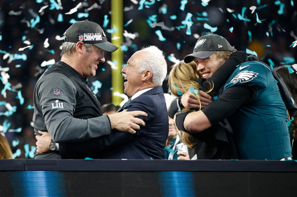 Coach Doug Pederson and Eagles owner Jeffrey Lurie (center) rejoice as they wait with Nick Foles to receive the Lombardi Trophy. Courtesy Michael Bryant / Staff Photographer
