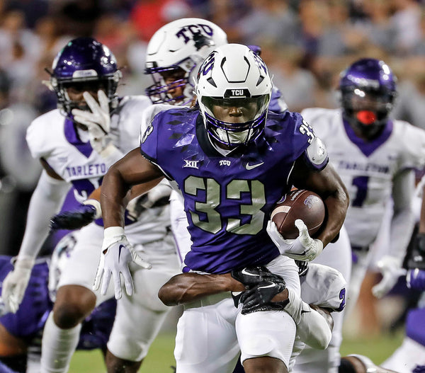 TCU running back Kendre Miller (33) gains some tough yards up the middle in the first half of a NCAA football game at Amon G. Carter Stadium in Fort Worth, Texas, Saturday, Sept. 10, 2022. TCU led Tarleton State 38-7 at the half. (Bob Booth / Special to the Fort Worth Star-Telegram)