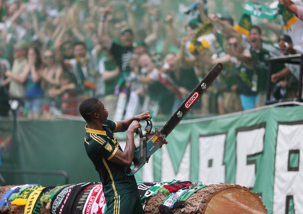 Portland Timbers forward Fanendo Adi (9) grabs up Timber Joey's chainsaw after scoring two consecutive goals as the Timbers beat rival Seattle Sounders, 4-1, at Providence Park in Portland on June 28, 2015. Randy L. Rasmussen/Staff