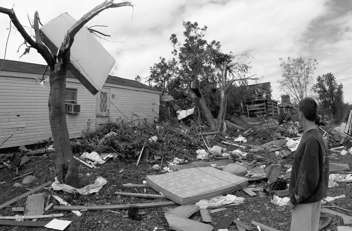 Residents look at debris on the ground and in trees after a tornado hit the community, Darkesville, September 17, 2004. The tornado caused major damage to multiple homes and businesses. Martinsburg Journal