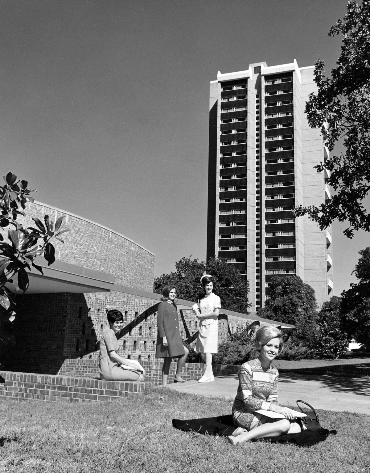 Students in front of the Redbud Theater, on the northwest side of Hubbard Hall at Texas Woman‘s University in Denton, circa 1965. Stark Hall Dormitory can be seen in the background. Courtesy Texas Woman’s University / #UAP 22.8.7